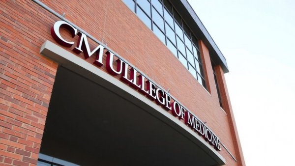 Modern building with CMU College of Medicine sign, Saginaw