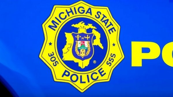 Michigan State Police emblem on patrol car, Michigan winter pet safety context.