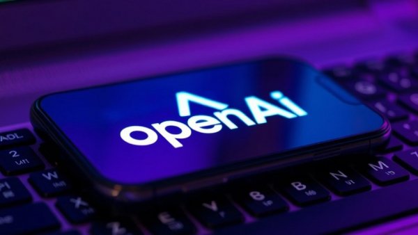 OpenAI logo smartphone on keyboard, AI agent service for businesses.