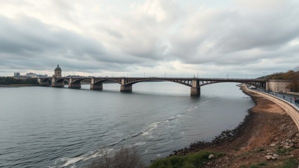 Bridge spanning a river in Michigan under overcast skies.