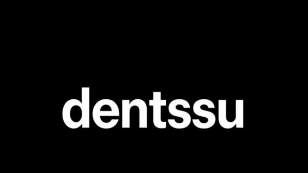 Bold 'dentsu' logo on black background symbolizing generative AI in digital marketing