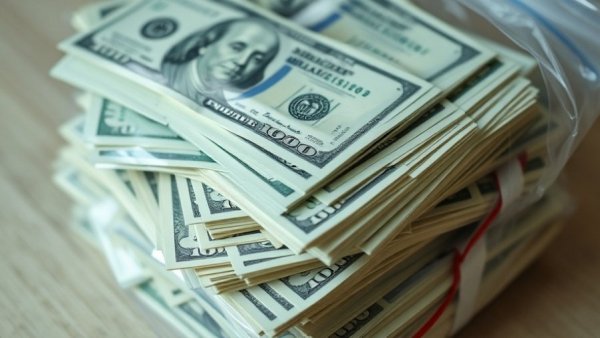 Stacks of fake cash in a bag, labeled for motion picture use in Michigan.