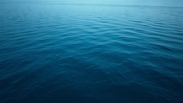 Calm ocean surface at twilight, suggesting tranquility.