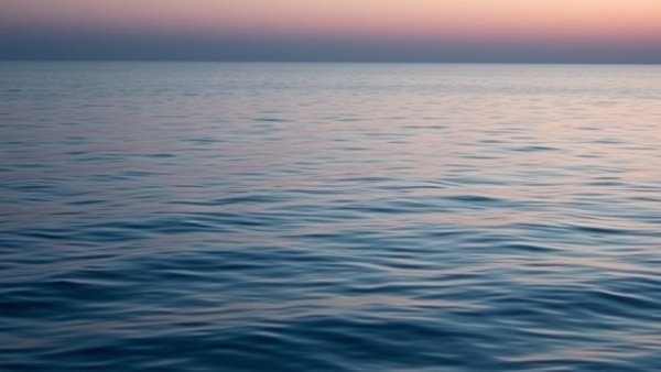 Tranquil ocean at dusk with rippling water and calm ambiance.
