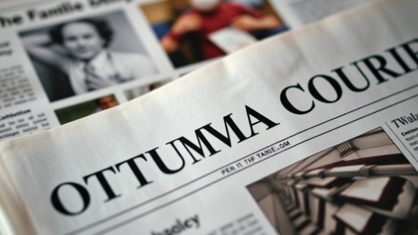 Ottumwa Courier newspaper headline in focus.