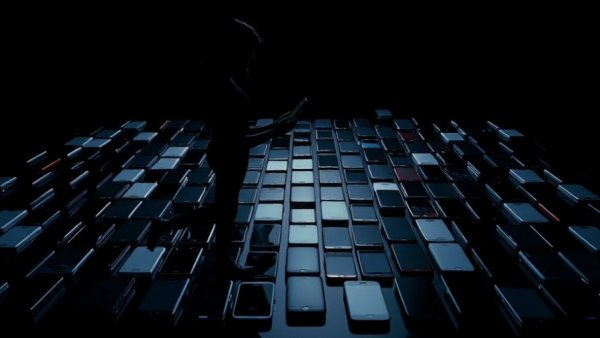 Tech gadgets displayed with a silhouette holding a smartphone.