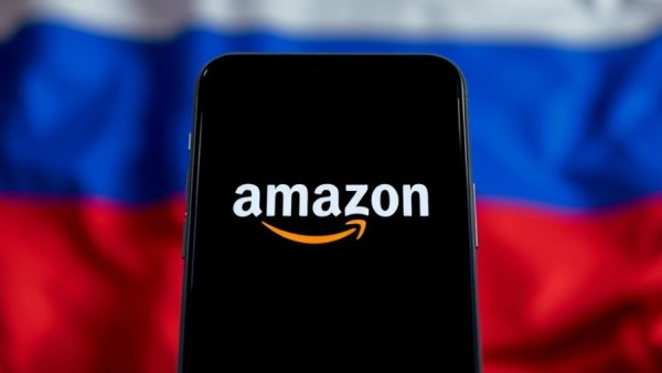 Amazon logo on phone over Russian flag, cyberattack theme.