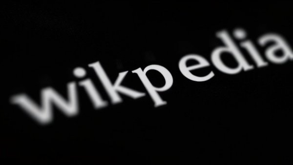 Wikipedia logo reflecting on screen, monochrome, Wikimedia AI Partnerships.