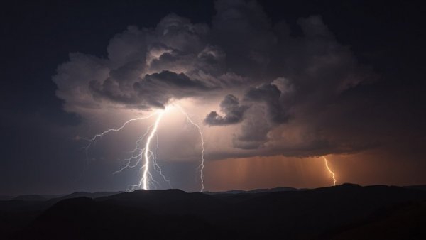 Dramatic lightning storm over hills at night, related to wildfire prevention.