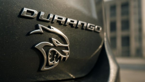 Durango Hellcat logo reflecting sunlight, close-up detail.