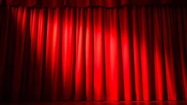 Adorable kids and animals on stage with red curtain backdrop.