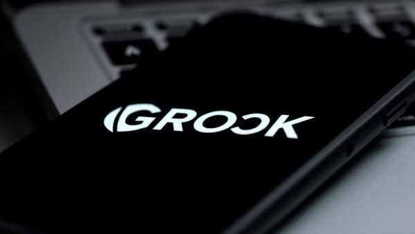 GROK logo on smartphone and laptop screens, technology theme.