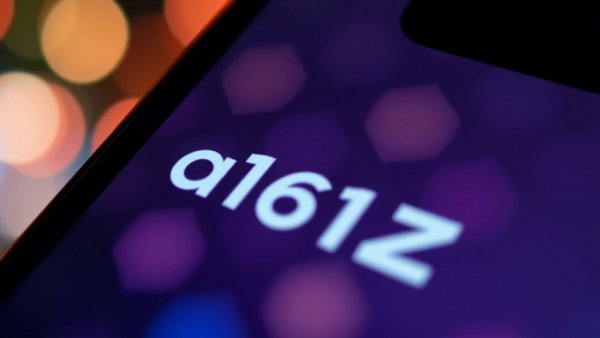 a16z logo on smartphone screen against colorful blurred lights.