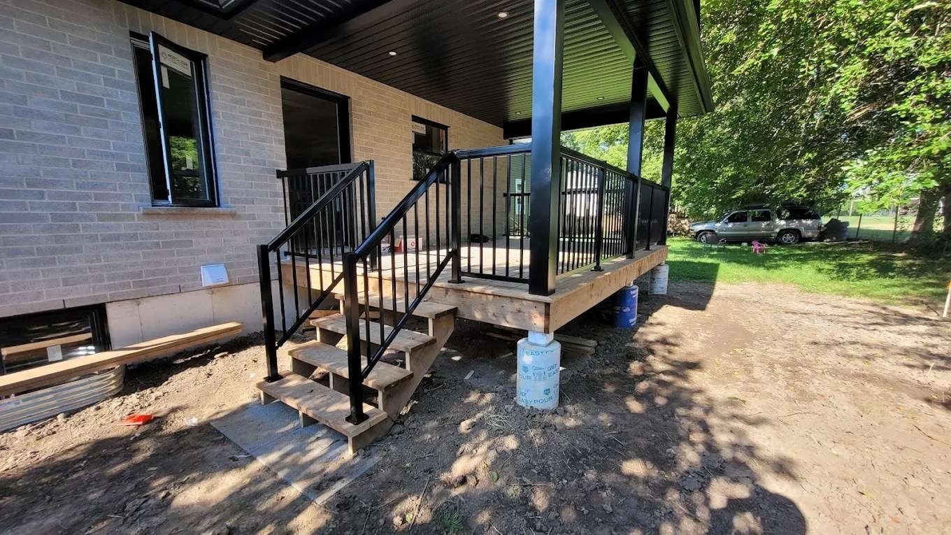 Outdoor deck with metal railings and overhang