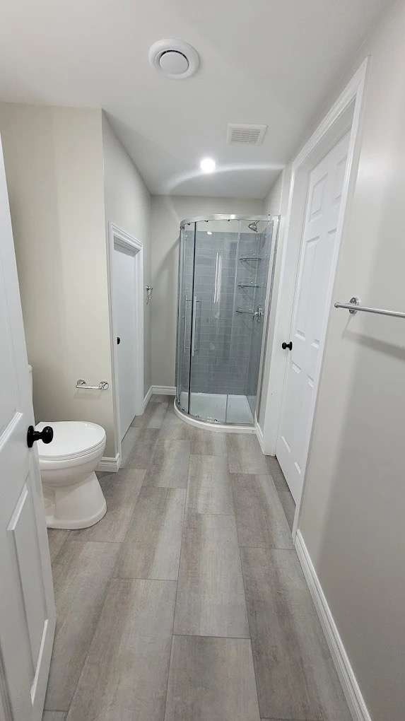 minimalist bathroom decor, calm and tidy, organizing toiletries, photorealistic, compact city loft bathroom with matte black fittings, highly detailed, reflections on tiles and subtle textures, crisp clarity, monochrome black and white, focused task lighting, shot with a 50mm standard lens.