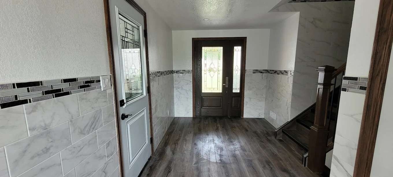 Hallway renovation with tiling, flooring and replacement doors