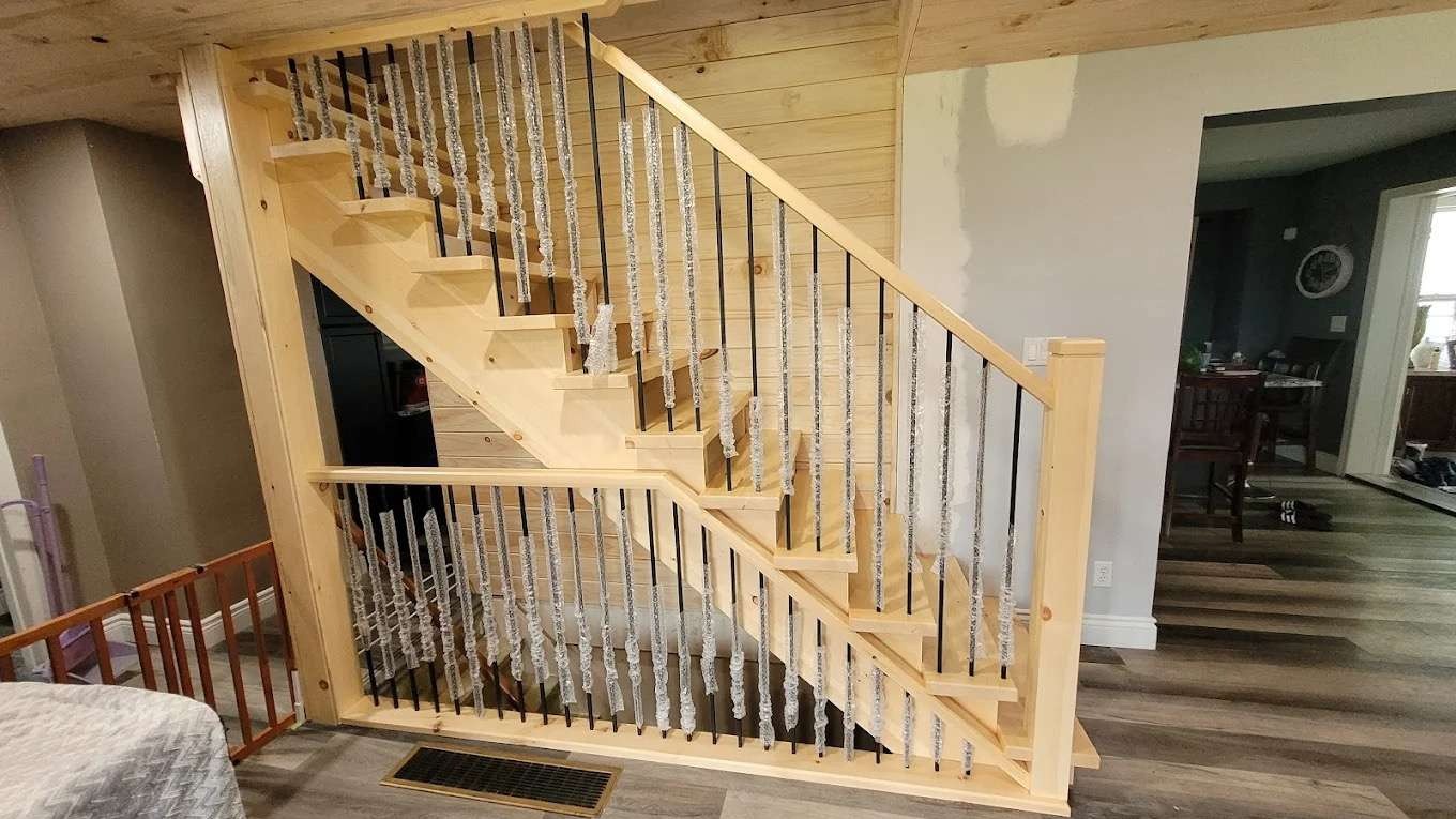 Wood stair and railing replacement by Thiessen Home Renovation