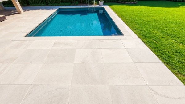 Modern pool deck refinishing options with lush garden and lawn.