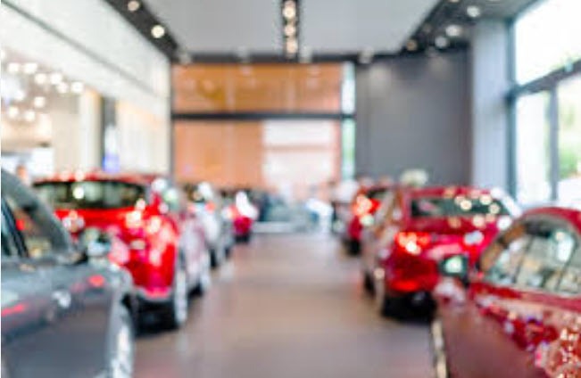 modern car dealership showroom Myrtle Beach, digital displays, customer browsing, cinematic dealership interior, blue and silver accents
