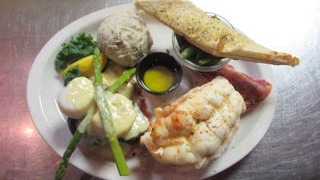 locals enjoying seafood at cozy hidden gem, friendly staff welcoming