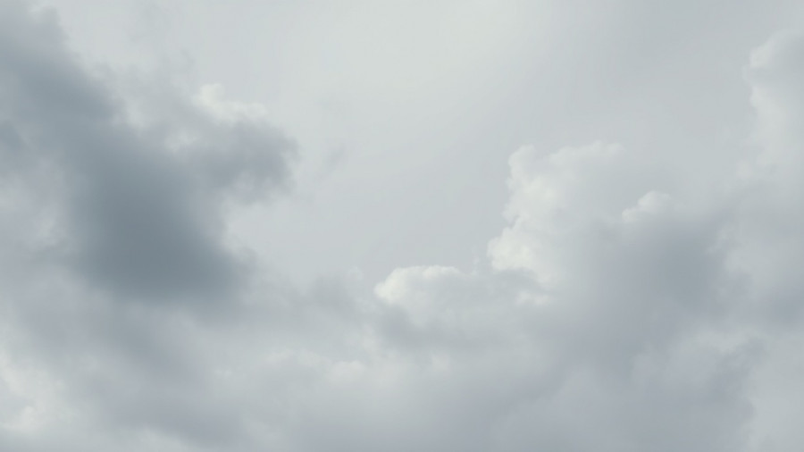Dynamic clouds peacefully drifting in a soft overcast sky.