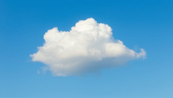 Serene fluffy white cloud in a clear blue sky, holiday travel 2025.