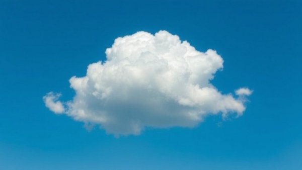 Soft white cloud drifting peacefully in an open blue sky.