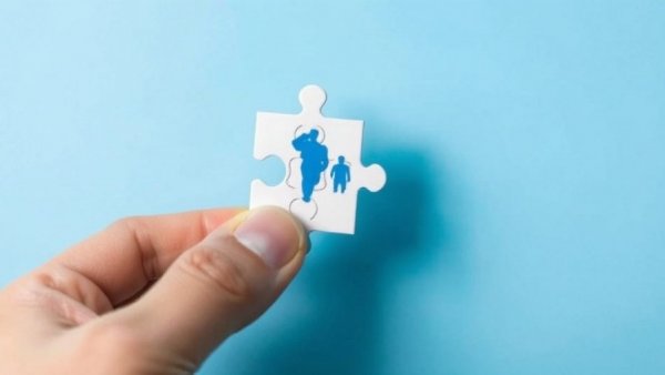 Hand placing puzzle piece symbolizing community design sustainability concept.