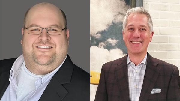 Two businessmen posing, representing Slumberland's Franchise Model.