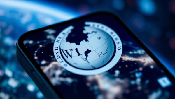 Smartphone displaying Wikipedia logo with digital network backdrop.
