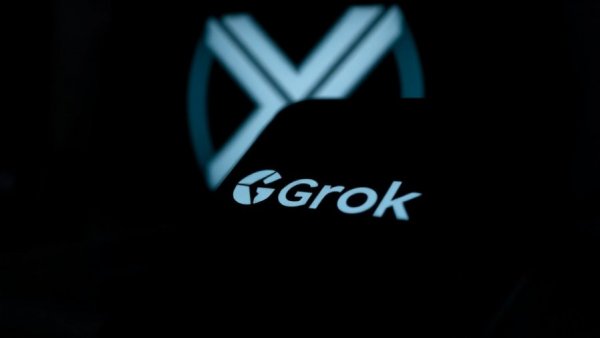 Grok logo on screen with blurred X logo, Grok image generation controversy.
