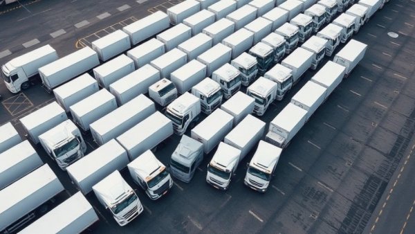Parked white trucks in California, highlighting self-driving logistics.