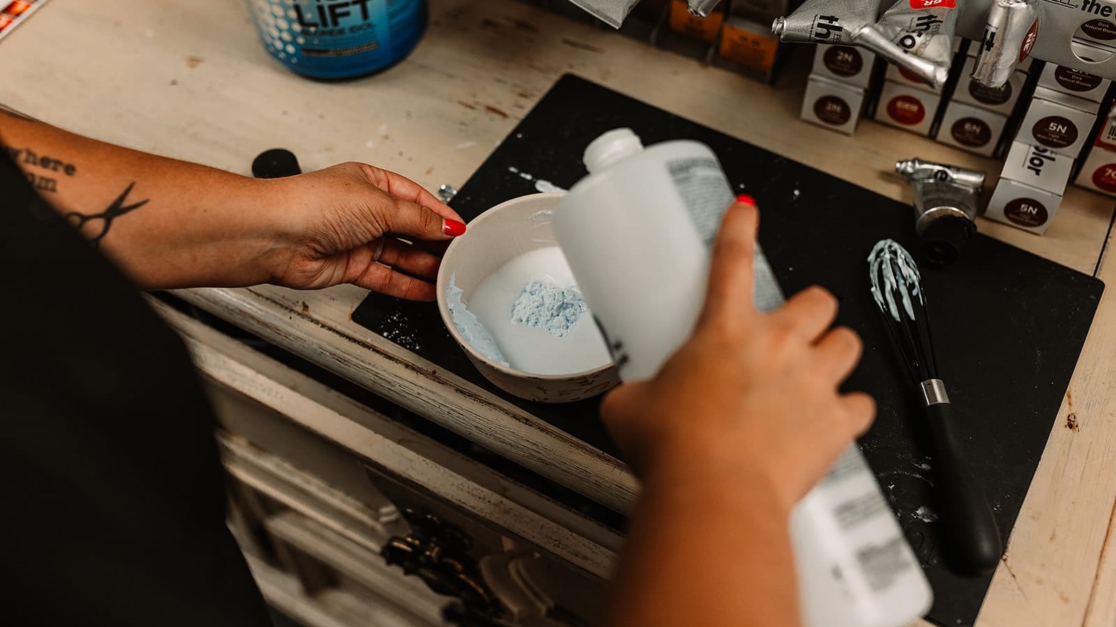 hairstylist emily alexander prepares a hair treatment serum