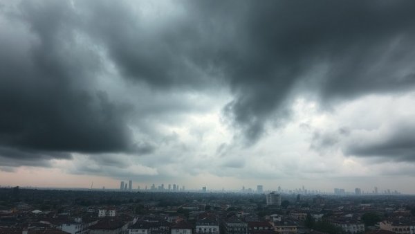 Overcast cityscape with dramatic clouds over urban rooftops.