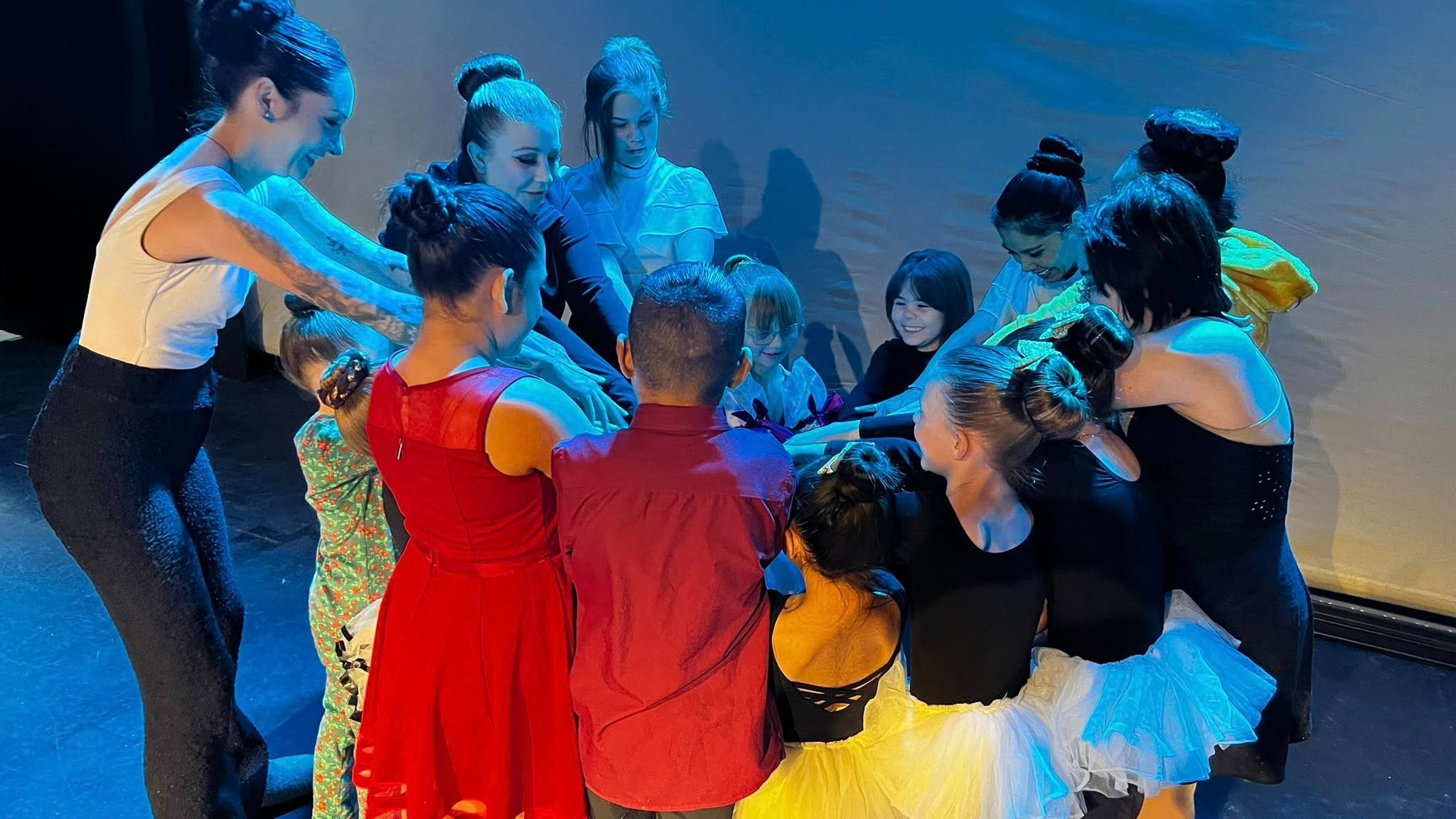 MCDC dance instructor guiding special needs student with gentle encouragement in inclusive dance program