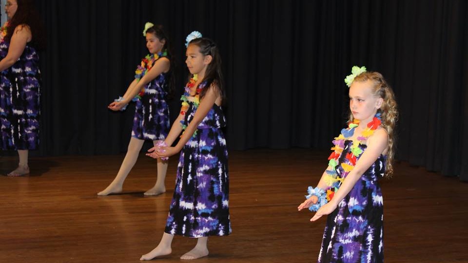 Inspiring dance teacher embracing student after class in MCDC inclusive dance program