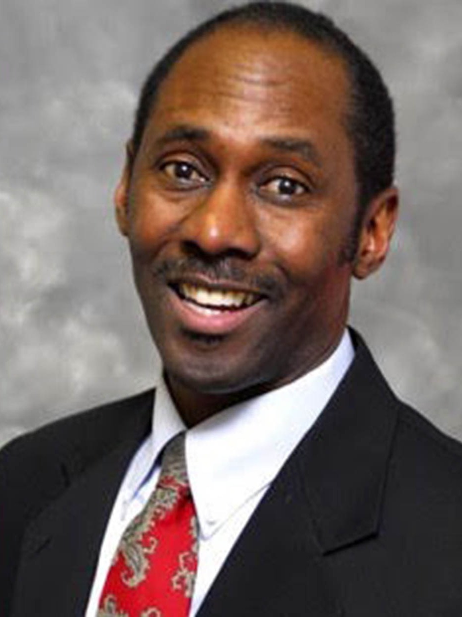 professional daley headshot, confident, staring directly at the camera, photorealistic, a simple gray backdrop, highly detailed, subtle movements in his facial muscles, 100mm macro lens, even studio lighting, shot with a Hasselblad H6D-400c