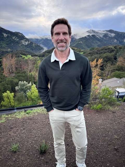 knowledgeable health coach, animated, giving a seminar, photorealistic, conference hall with seated audience, highly detailed, expressive gestures, highly defined, primary colors, spotlight lighting, shot with a 85mm lens.