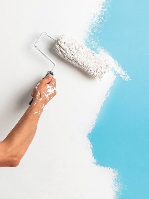 creative painting wall, bold expression, decorated with vivid murals, photorealistic, urban setting with graffiti elements, highly detailed, dynamic perspective, high resolution, bright hues, harsh sunlight, shot with a wide-angle lens.