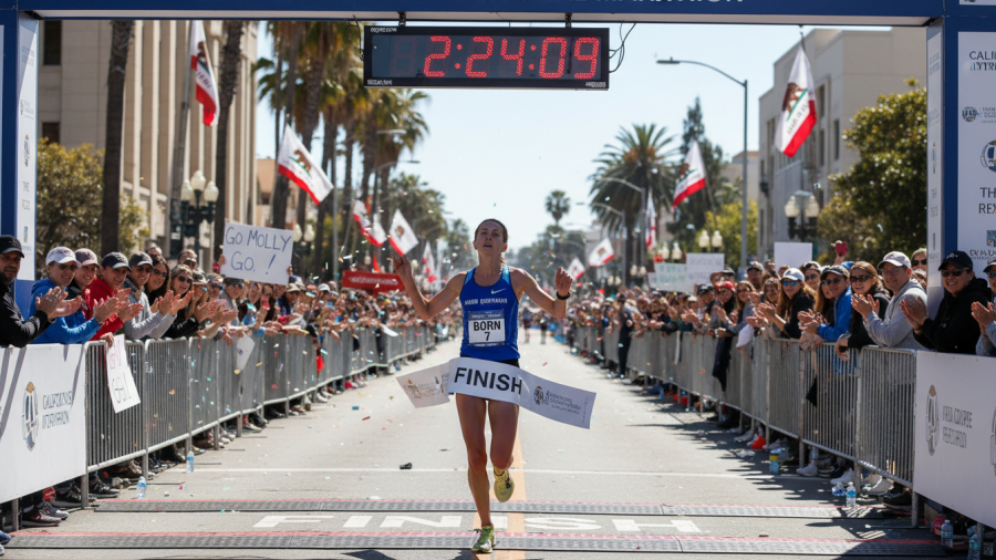 Molly Born finishes the Sacramento Marathon, achieving 2:24:09 with community support.