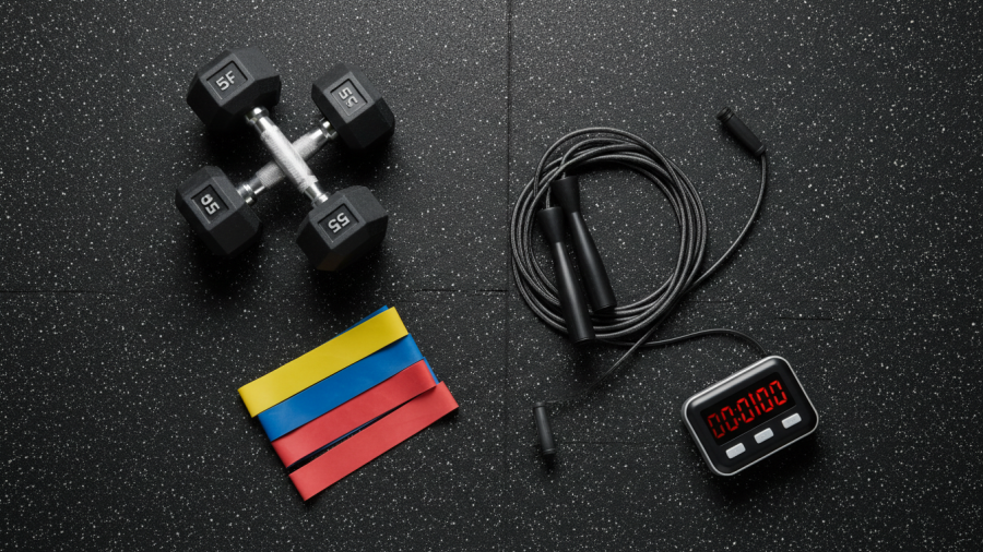 Flat-lay of workout tools on a gym floor showcasing exercise consistency and workout intensity.