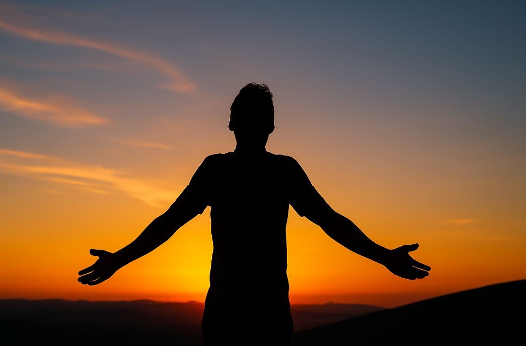 Person breathing deeply outdoors as a symbol of calm, resilience, and inner power.