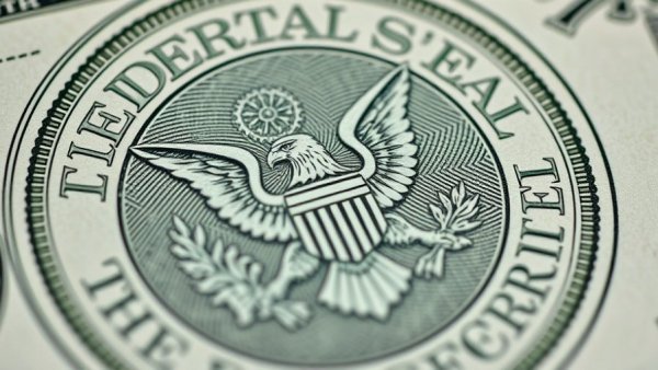 Detailed view of Federal Reserve Seal on dollar bill related to UAMS minimum wage increase.