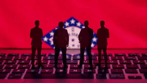 Silhouette figures on keyboard with Arkansas flag and jobs text