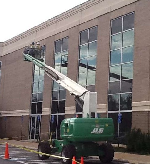 Technician re-caulking old window frame for waterproofing repair work