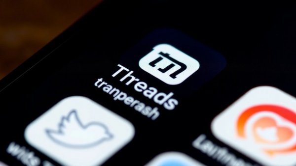 Close-up of Threads app icon on smartphone screen with other apps.