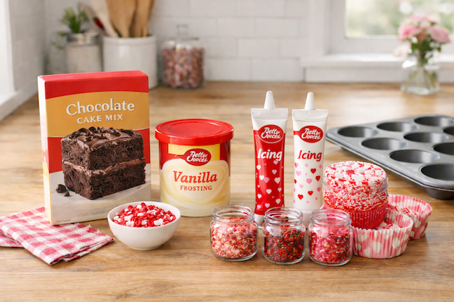 Mixing cake batter and canned frosting for easy homemade Valentine cupcakes in a home kitchen