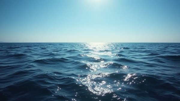 Calm ocean waves moving under blue sky, illustrating 'how fast do ocean swells travel'.