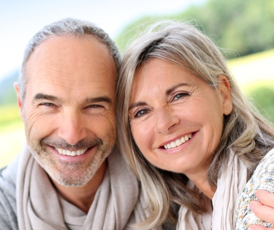 Couple with beautiful smiles after mono dental implants