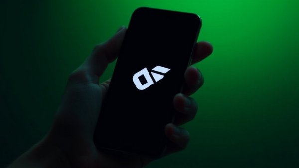 Smartphone screen displaying logo in hand, green backlight, digital art.